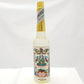 Bottle of Agua de Florida with decorative floral label on a white background.