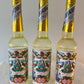 Three bottles of Agua de Florida with colorful floral labels on a crisp, clean setting.