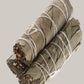 Multiple rolled-up Eucalyptus smudge bundles tied with twine on a white background