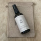 Small dark bottle labeled 'Pavana', pure essential oil blend,  on a hessian bag.