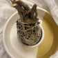 Single Californian White Sage Wands tied together, a close up shot from bottom view in a yellow and white smudge stick holder.