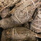 Bundles of Californian White Sage  wands tied together, used for smudging to offer, purify and cleanse spaces or individuals.