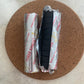 Two rolls of 'Three Kings' smudge charcoals, one opened showing the charcoal discs and the other closed.
