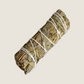 Stock image of a bundled mugwort smudge stick. Plain white, undecorated background.