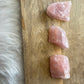 Three Rose Quartz Chunks on a slice of timber 